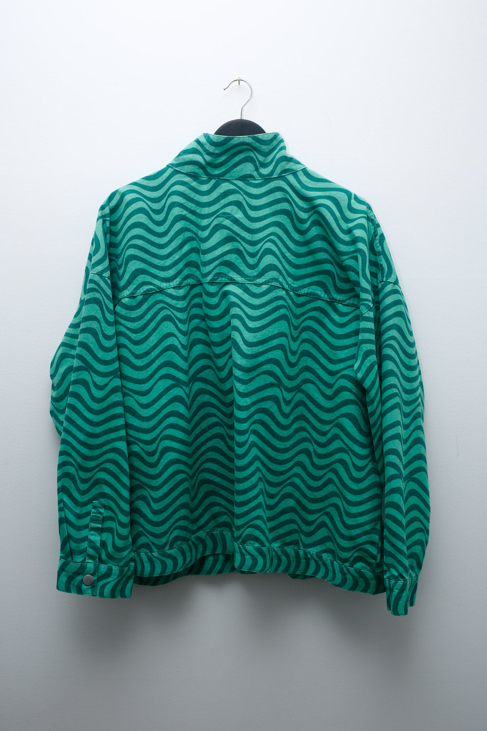 90s green bomber jacket with wavy print, snap buttons, and utility pockets