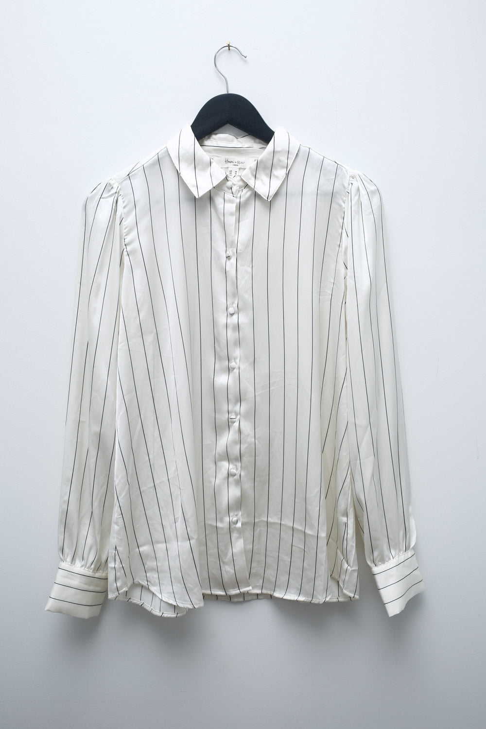 Vintage Hannah Blair white satin blouse with black vertical stripes, button-up front, and long sleeves with cuffed wrists.