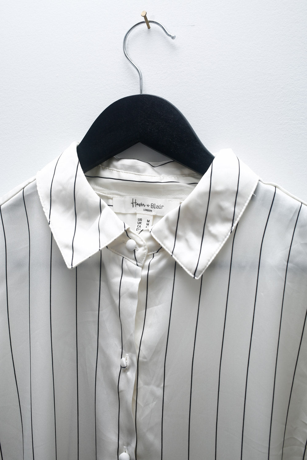Vintage Hannah Blair white satin blouse with black vertical stripes, button-up front, and long sleeves with cuffed wrists.