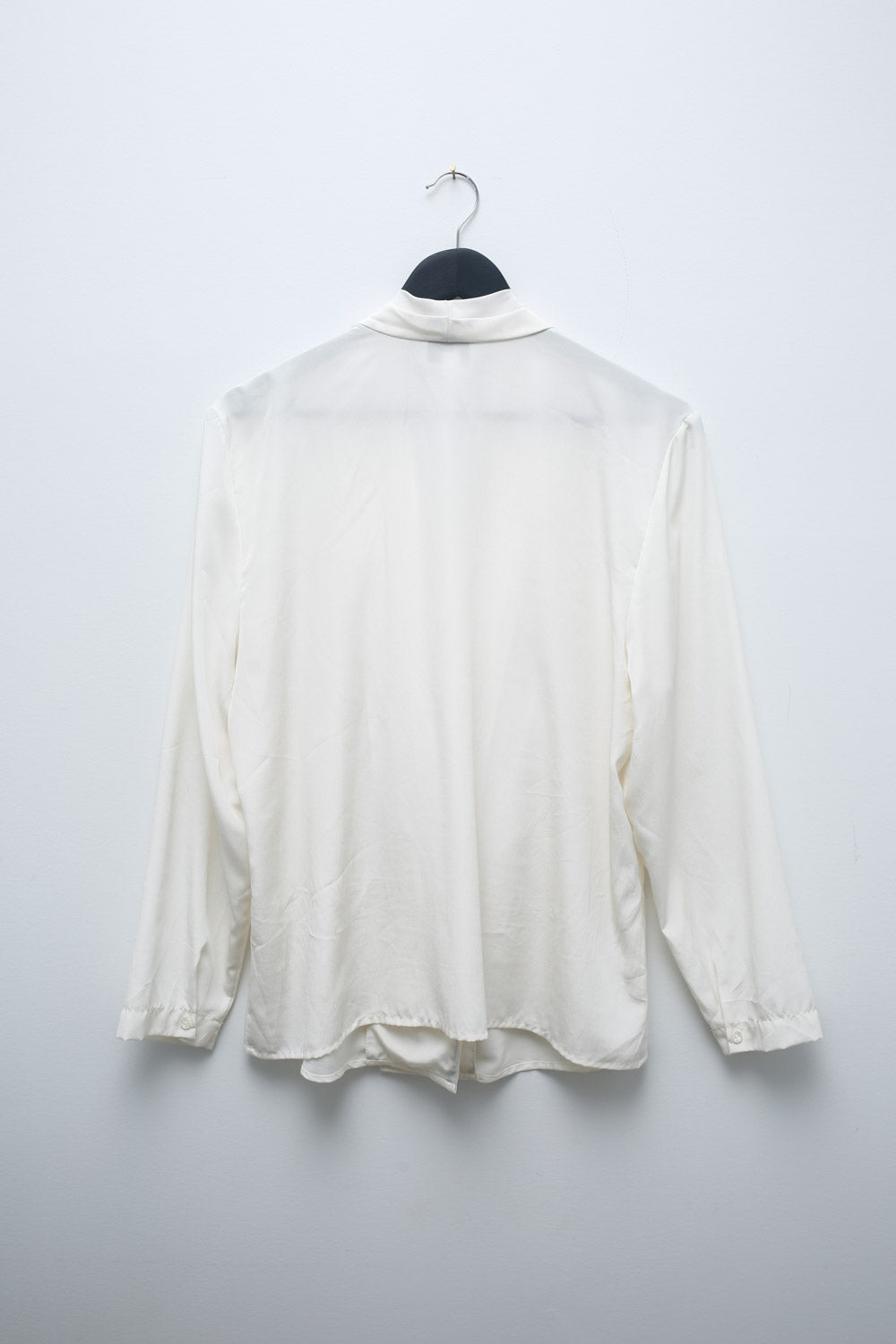 Vintage San André white satin blouse with draped wrap-style front, long sleeves, pleated neckline, and button closure.