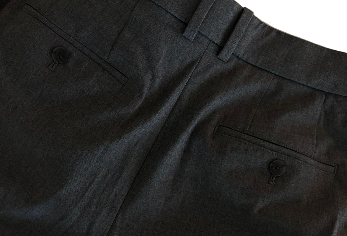 Dark gray pants with a belt on a beige background